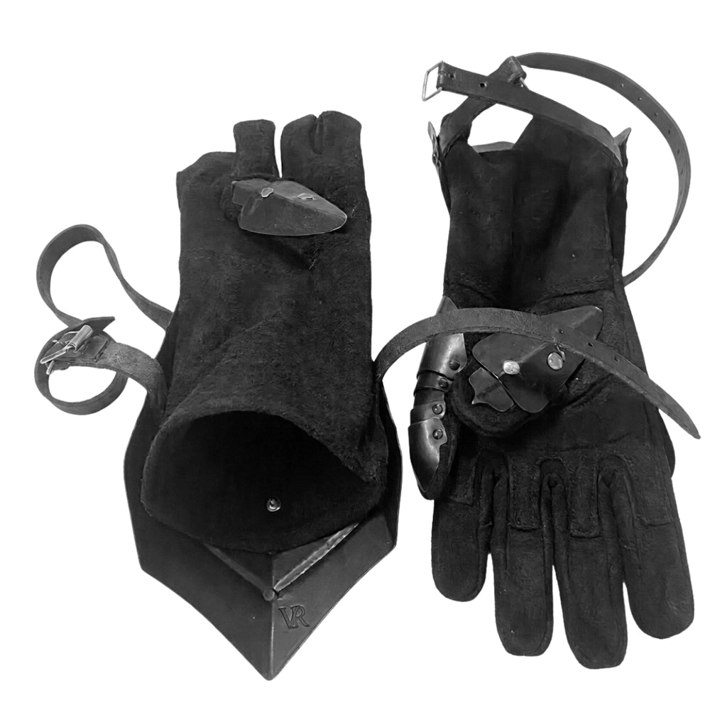 Interior view of medieval gauntlets showing leather straps and padded gloves.